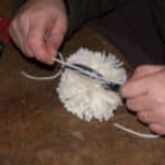 finir le pompon