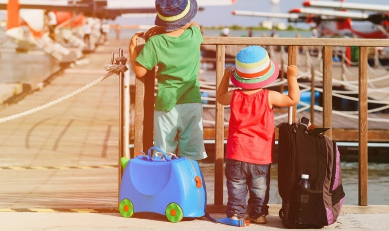deux enfants qui partent en voyage et regardent des avions